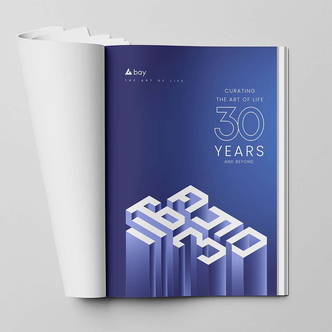 Bay Developments anniversary identity printed across a magazine spread